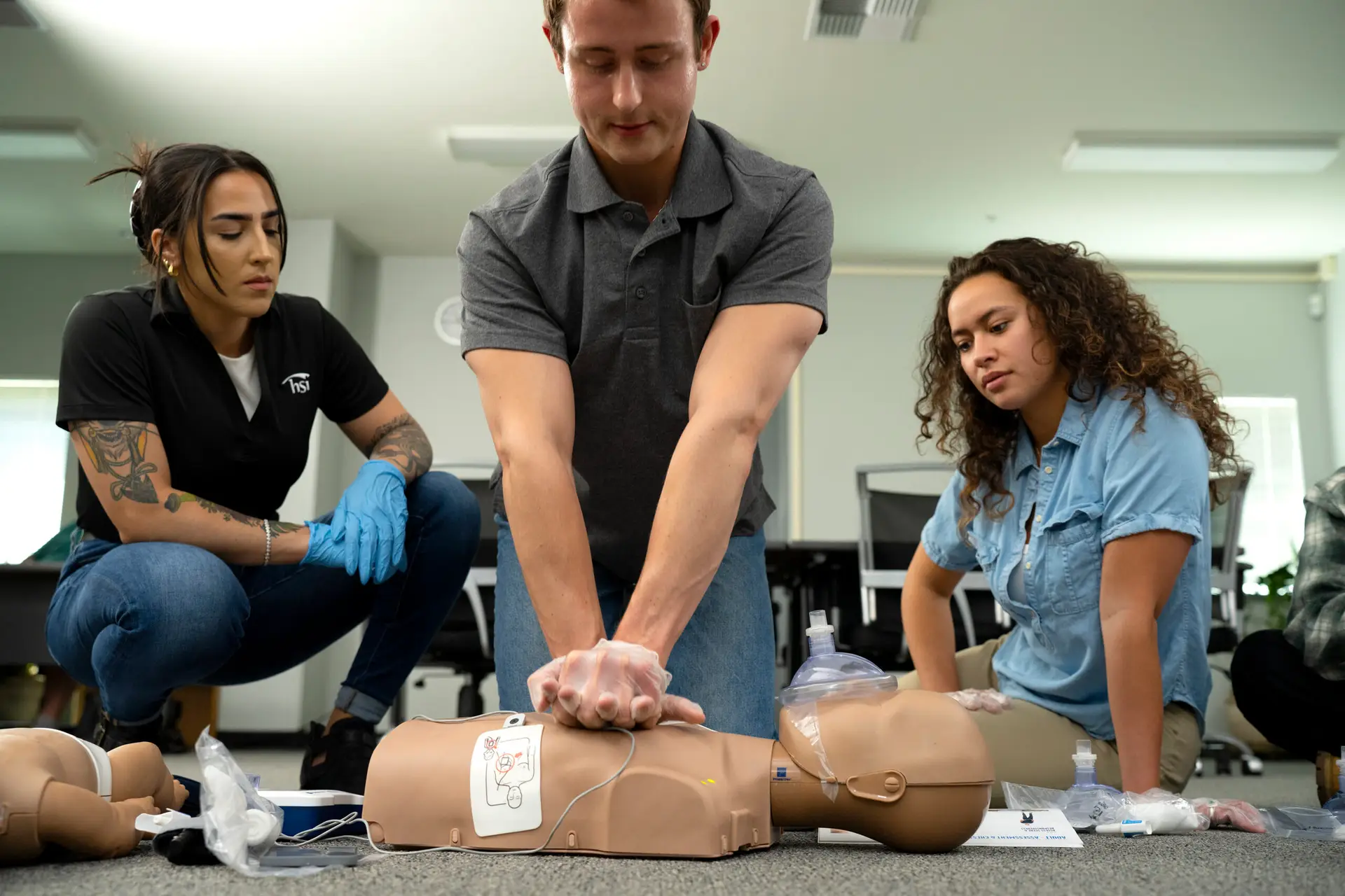 Instructor with student doing compressions